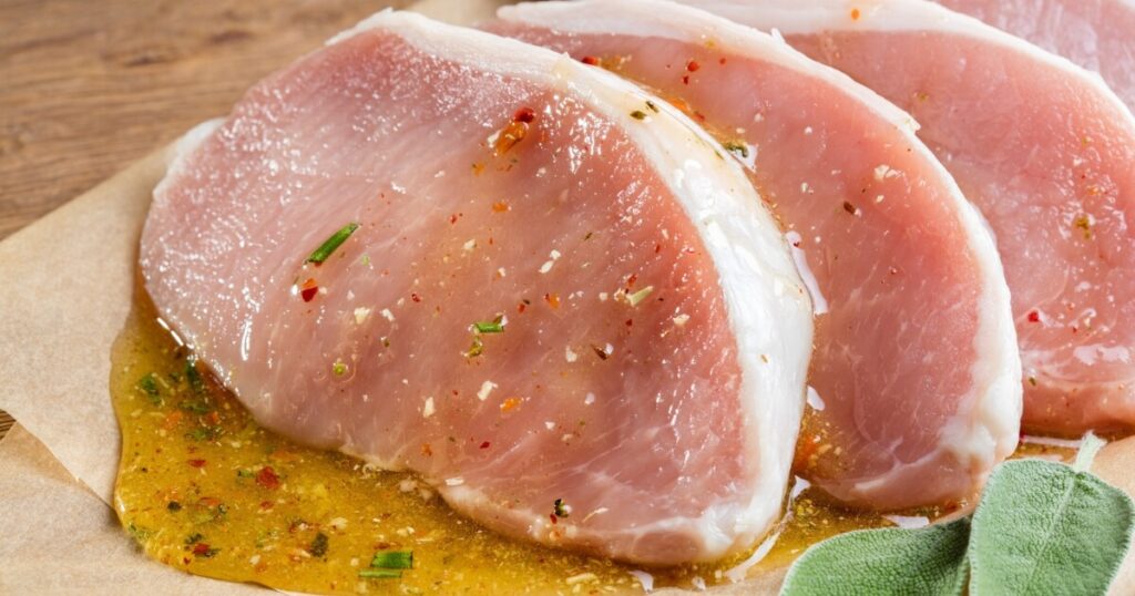 boneless pork chops on cutting board