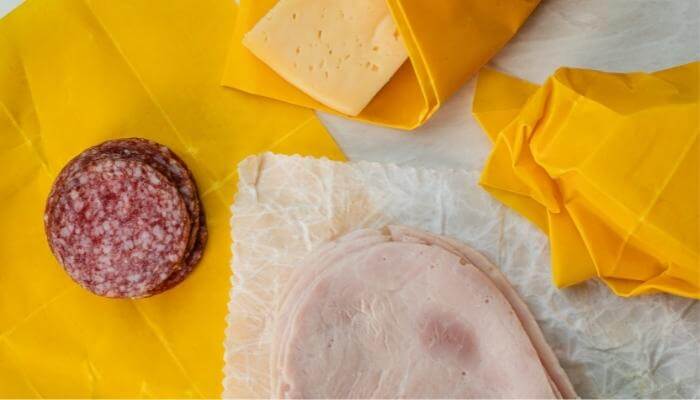 cold cuts and cheese on wax paper