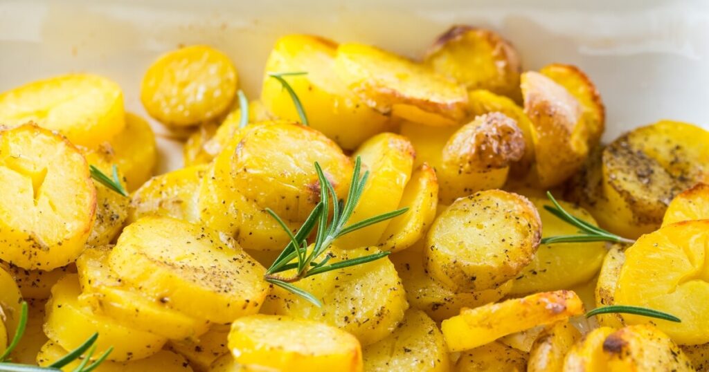 cooked potatoes cooling on baking sheet