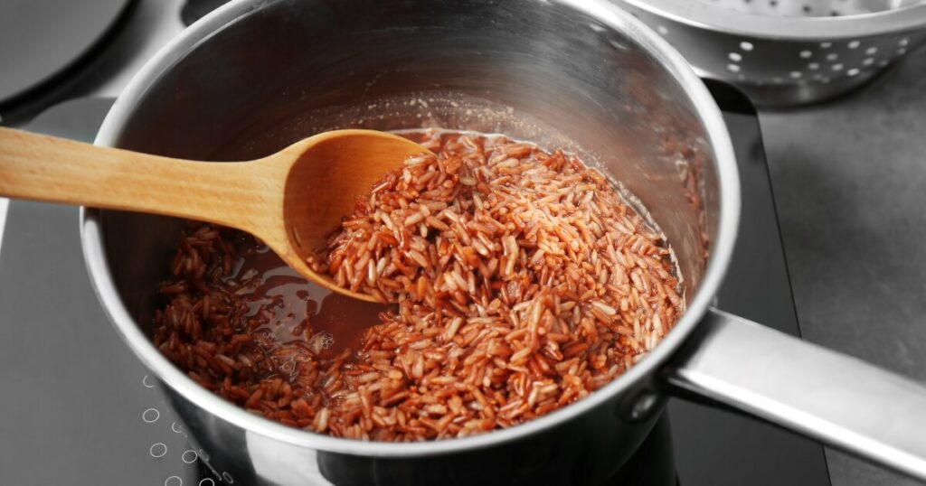 cooking rice with spices in saucepan