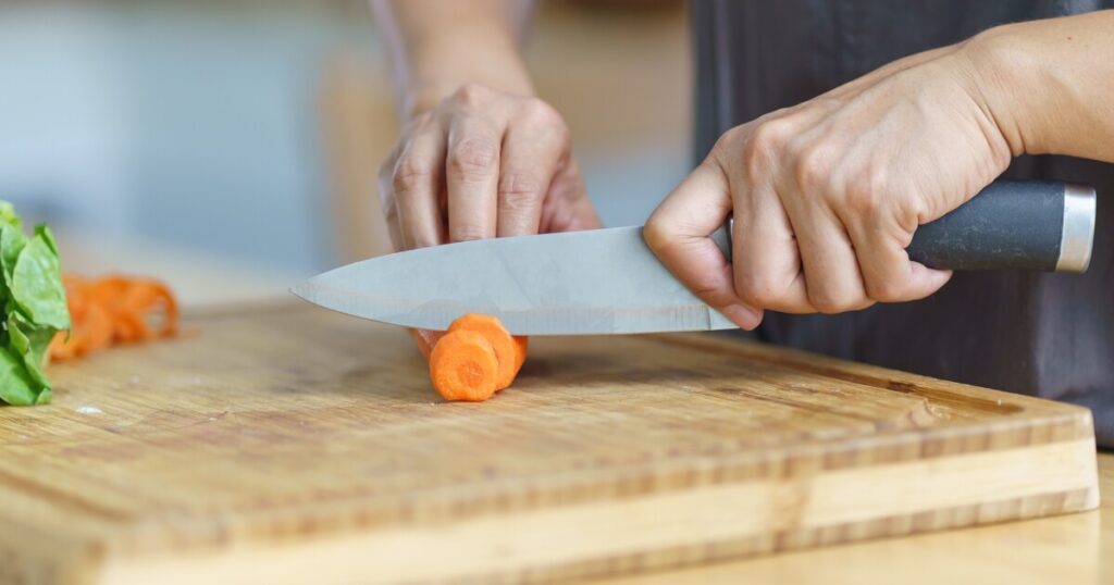 cutting carrots with chef knife