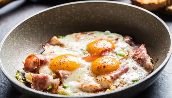 eggs bacon in ceramic pan