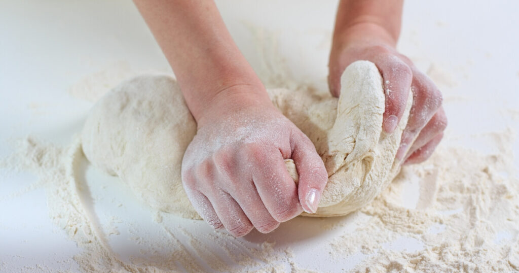 kneading dough on counter