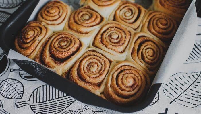 parchment lined tray of cinnamon buns