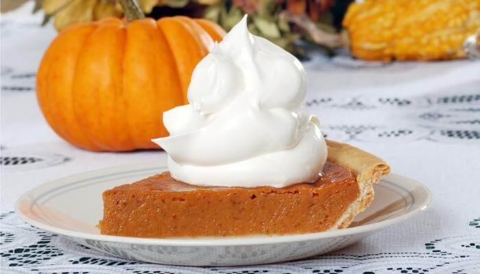 pumpkin pie slice lots of whipped cream