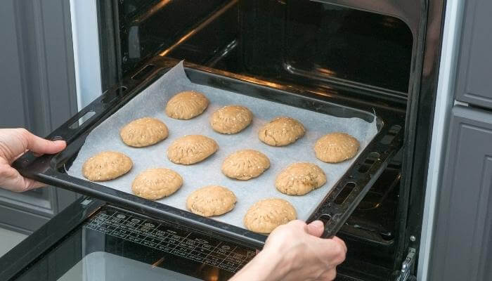 putting cookies in the oven single sheet