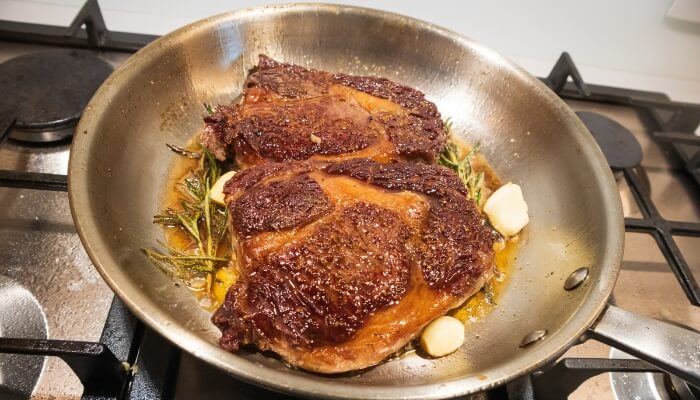 searing meat stainless steel pan