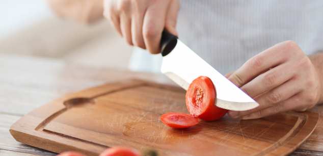 sharp knife slicing tomato