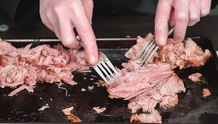 shredding pork with forks