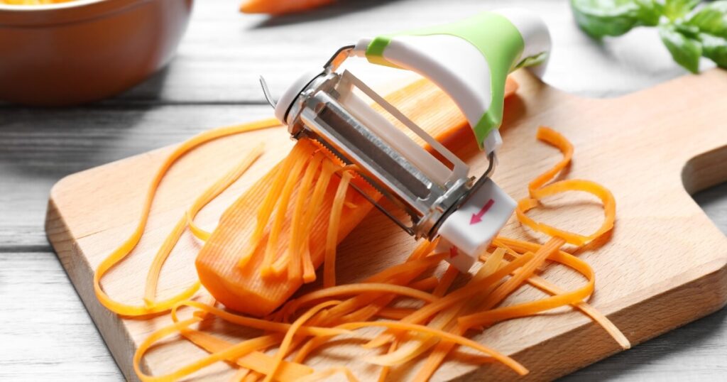 vegetable peeler with strips of carrot