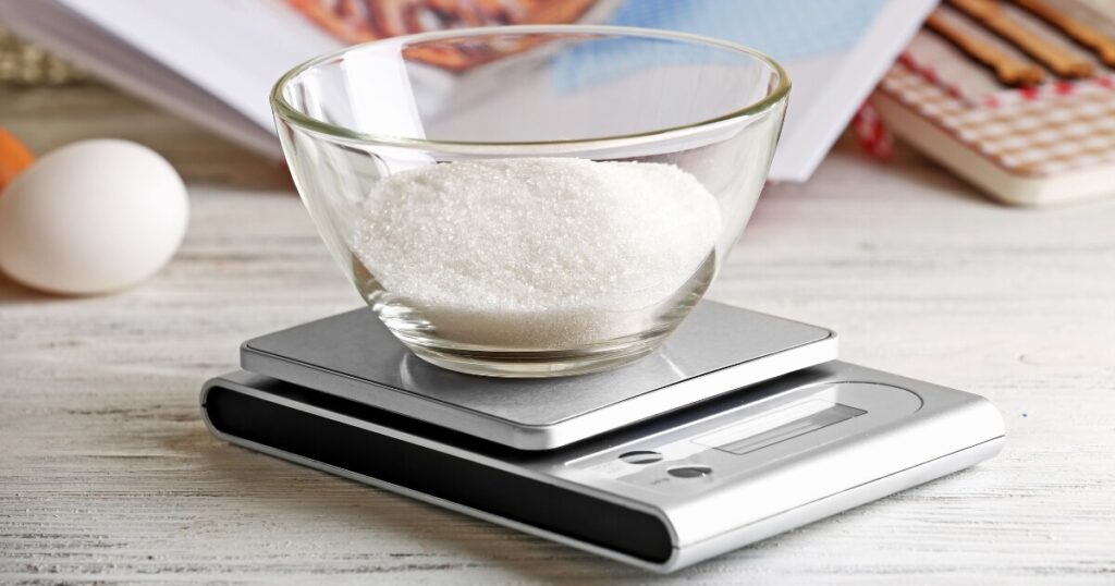 weighing sugar on kitchen scale