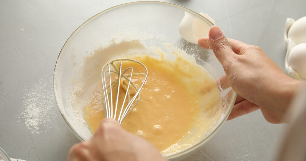 whisking eggs and flour